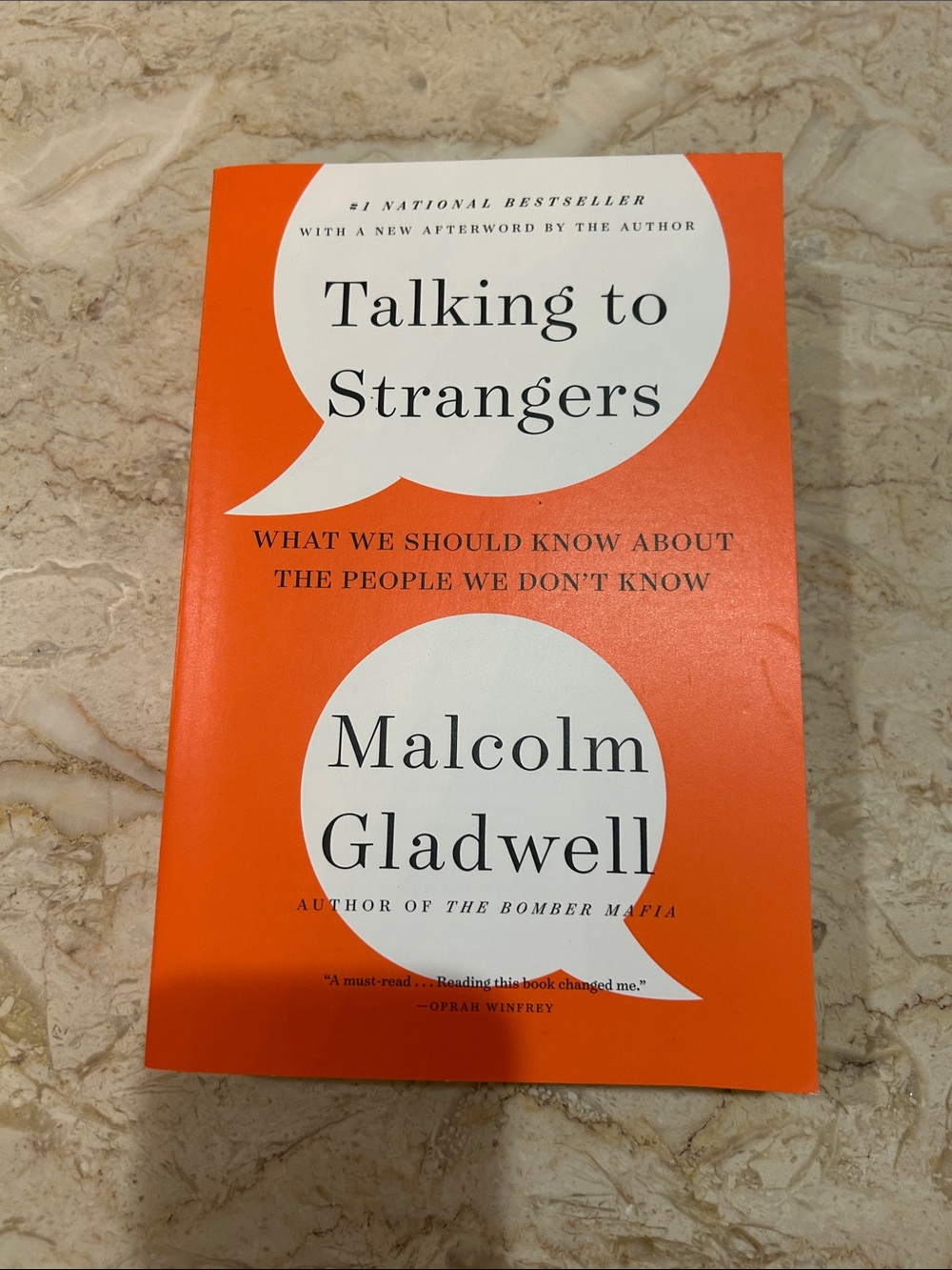 Talking to Strangers by Malcolm Gladwell - Bright Orange Paperback